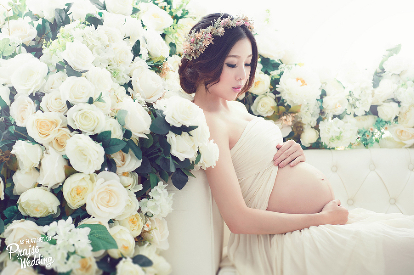White blossoms and lively greens, this romantic maternity photo says so much about  a mother