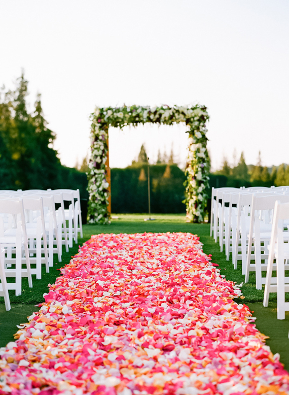 Romantic pink flower petal wedding aisle