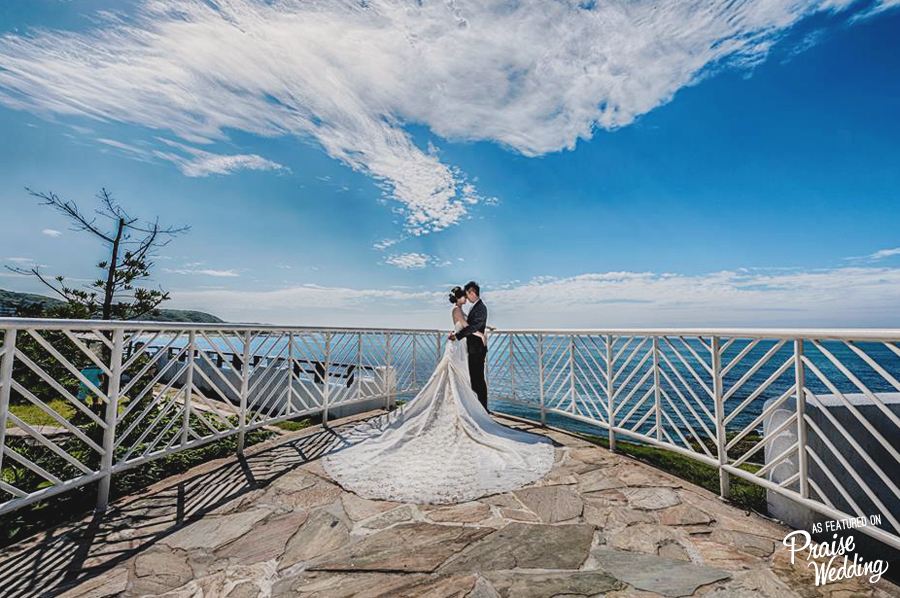 Loving the light-filled blue sky, breathtaking view, and the Bride's elegant long train!