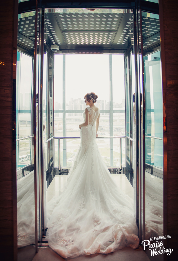 From the elegant bridal look to the amazing city view through the elevator glass, everything about this bridal portrait is incredible!