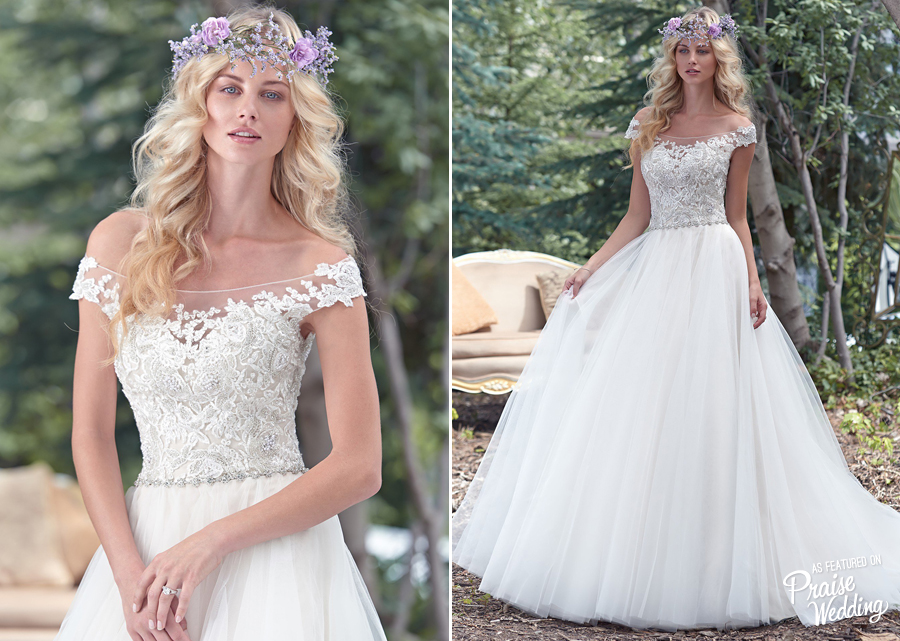 A delicate illusion off-the-shoulder neckline coupled with beautiful lace bodice, flowing tulle skirt, and a Swarovski crystal belt! This Maggie Sottero gown is so chic!