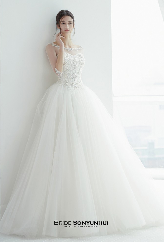 The illusion jeweled neckline creates the prettiest lace necklace! This dreamy gown from Sonyunhui is making us swoon!