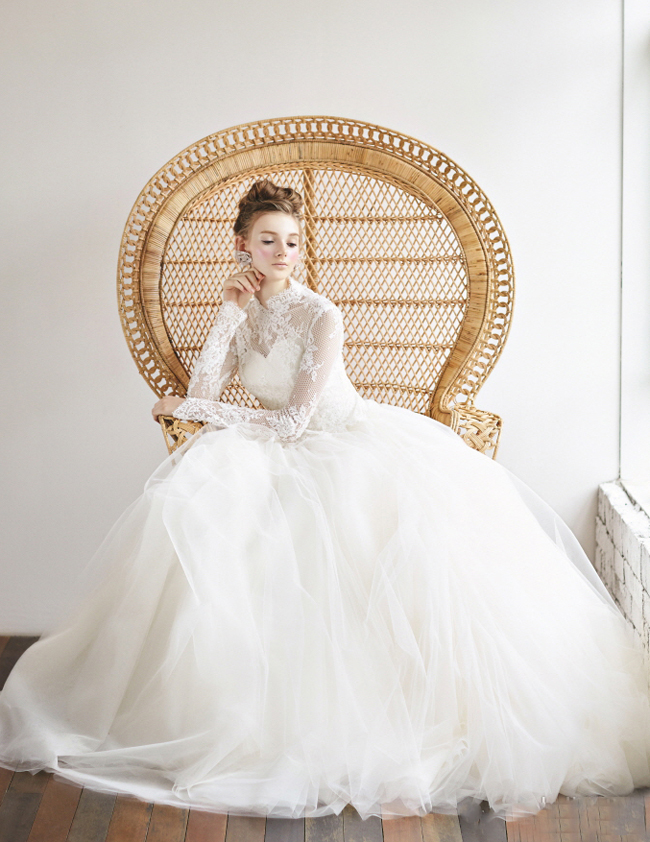 This vintage-inspired gown from Bride Merci featuring illusion sleeves and delicate lace is making us swoon!