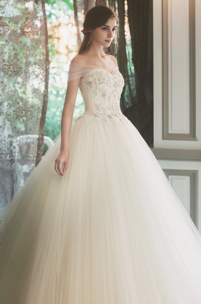 This dreamy off-the-shoulder gown from Sonyunhui featuring illusion sleeves and a jeweled bodice is making us swoon!