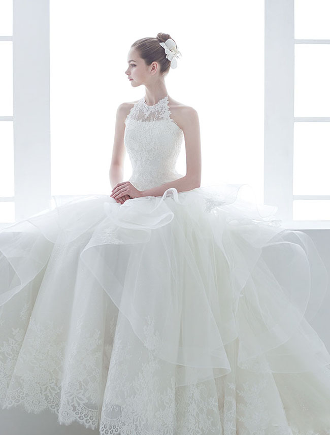 In love with this wedding dress from J Sposa featuring laced halter neck design and romantic ruffles!