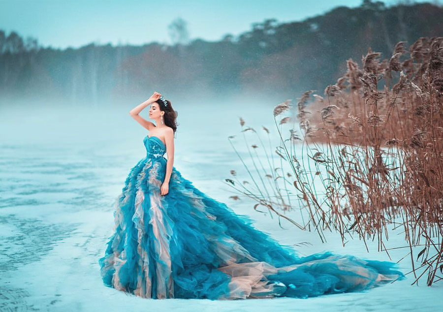 Stunning bridal portrait in the snow featuring a gorgeous ombre blue ruffled gown!