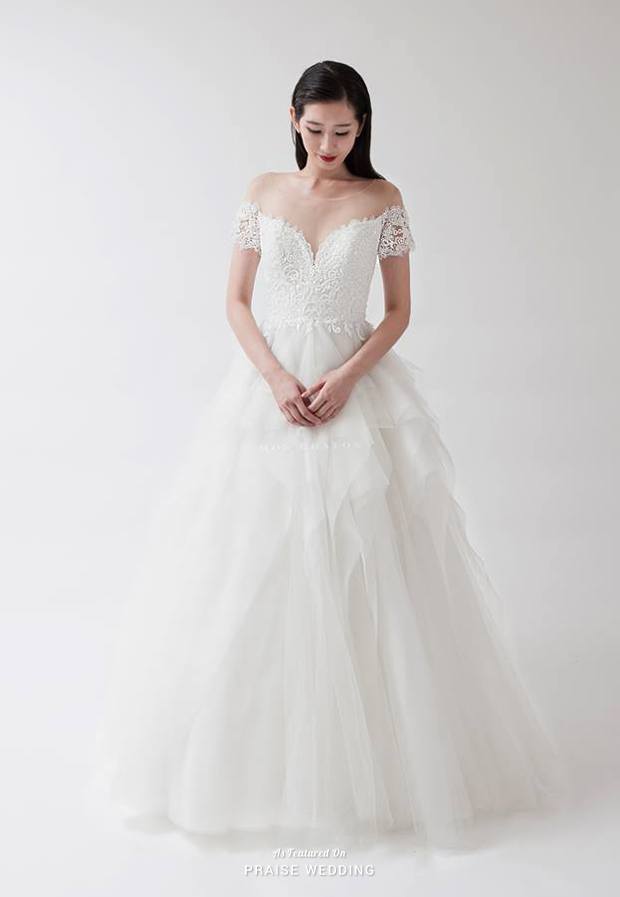 This airy ruffled gown from Mon Chaton featuring delicate laced sleeves and illusion neckline is the definition of pure romance!