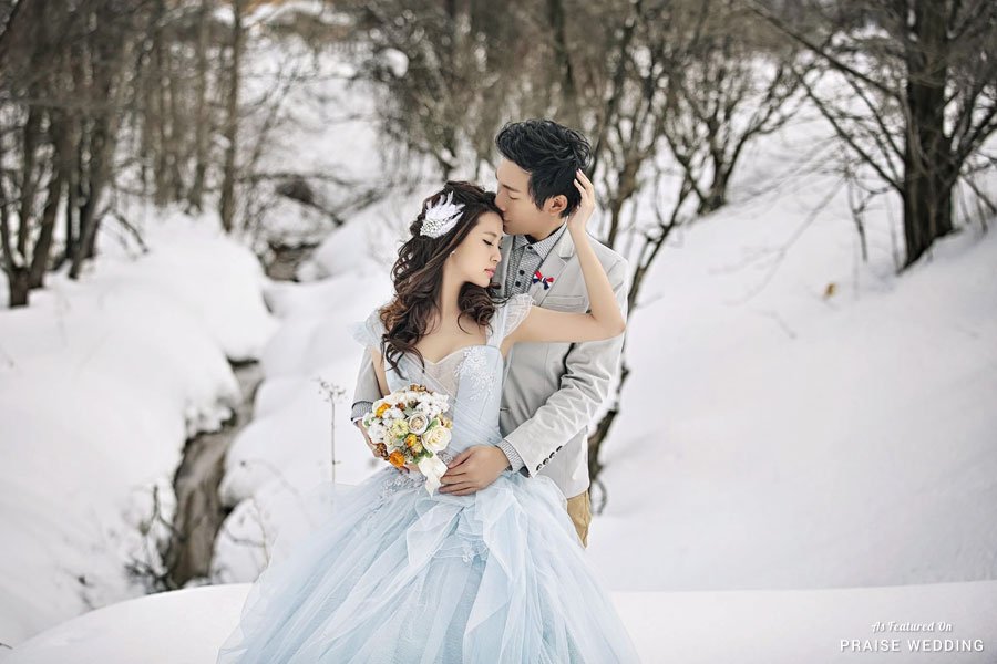 This snowy prewedding photo deserves to be framed! The Bride is a stunning vision in her ice blue gown!
