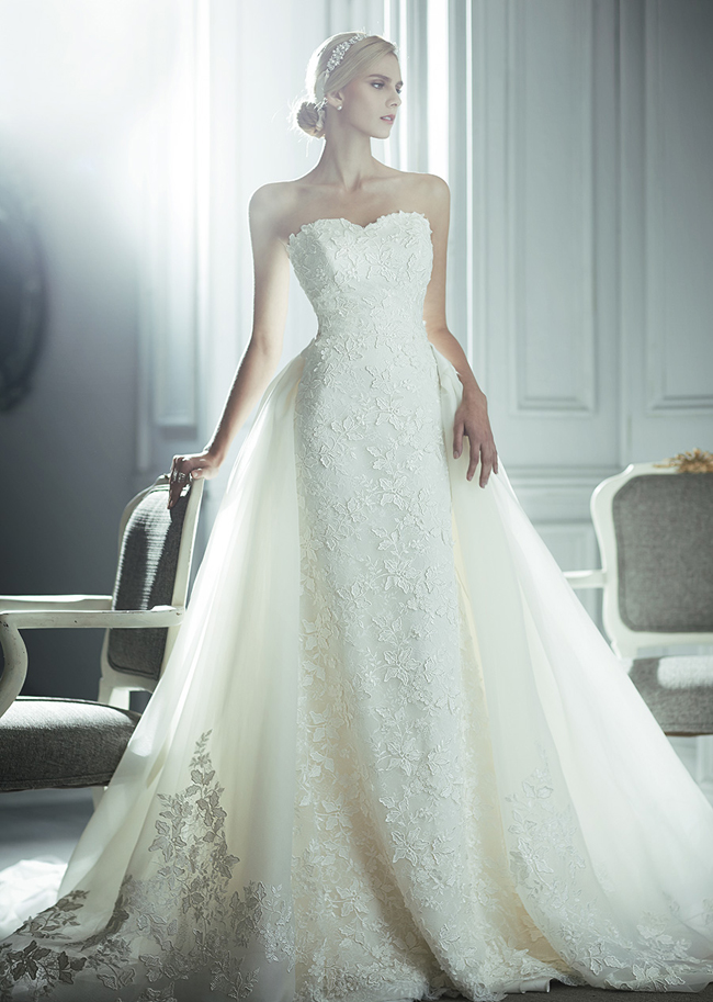 Sophisticated and elegant wedding dress from La Poeme featuring meticulously detailed lace and a romantic detachable train!
