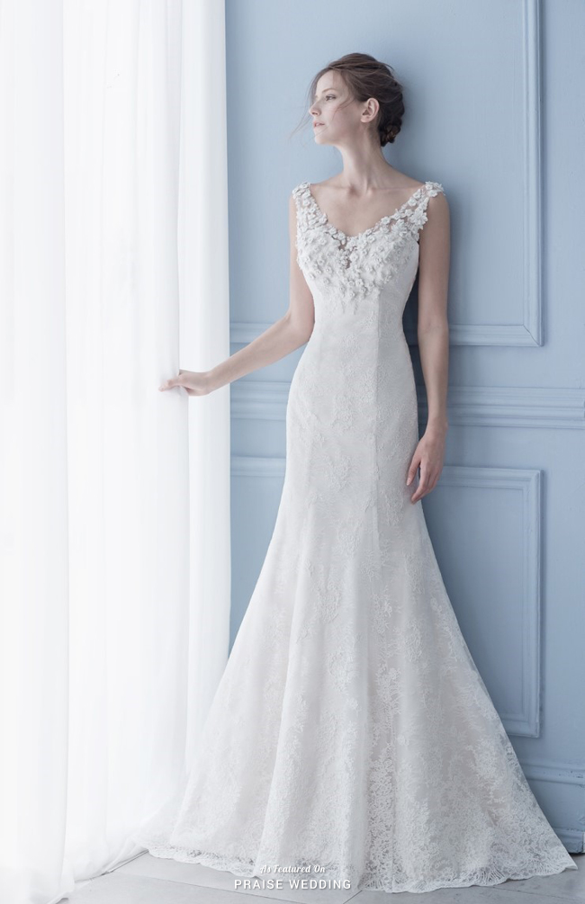Playing with sophisticated seaming and three-dimensional floral appliques, this fitted wedding dress from Kim Young Hee is making us swoon!