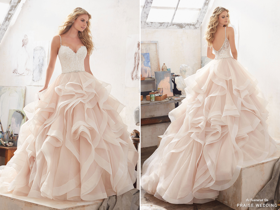 A sweet glamorous blush ball gown from Morilee featuring a frosted lace bodice accented with crystal beaded straps, and dreamy layers of flounced organza trimmed with horsehair!
