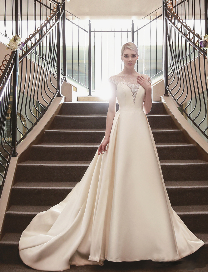 Distinguished jewels meet structured silhouette in an elegant symphony, this classic gown from Kimmisook Wedding is a show stopper!