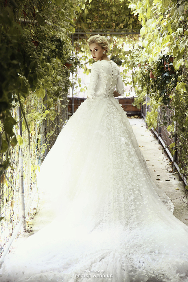 Say hello to your dream come true in wedding dress from Chana Marelus featuring chic floral applique, vintage-inspired sleeves, and a dreamy train!