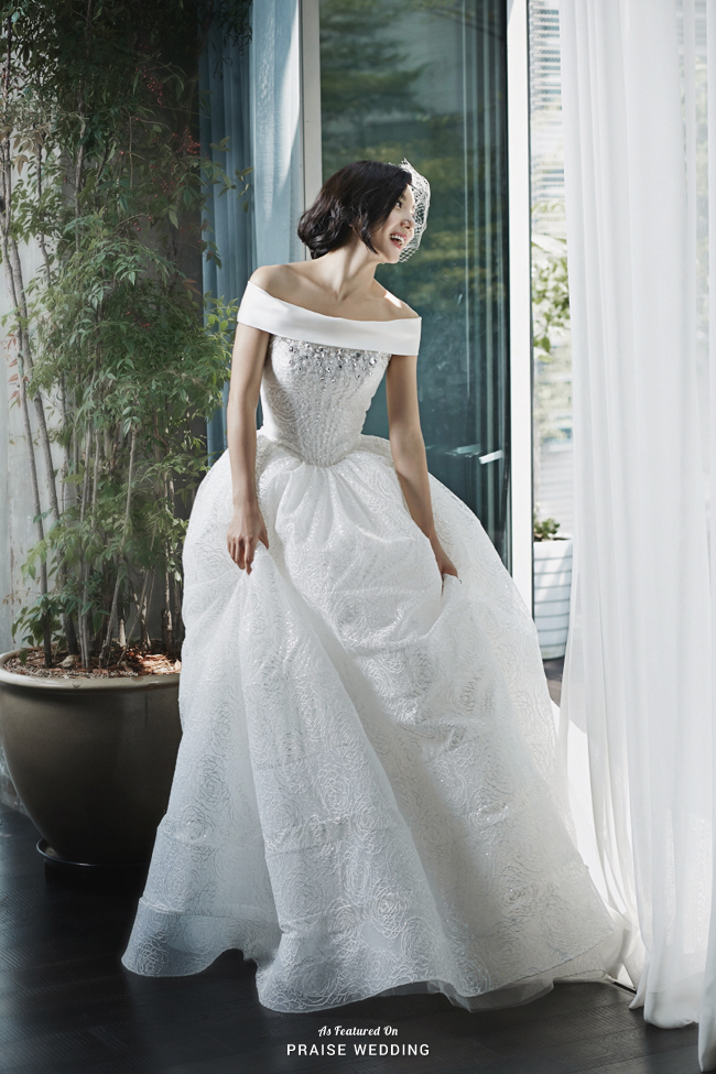 This classic off-the-shoulder gown from Dearte featuring unique patterns and beading is beyond incredible!