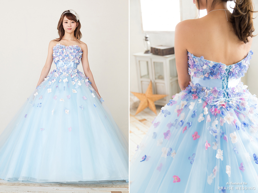 This voluminous blue ball gown from TuNoah Wedding featuring adorable floral appliques is making us swoon!